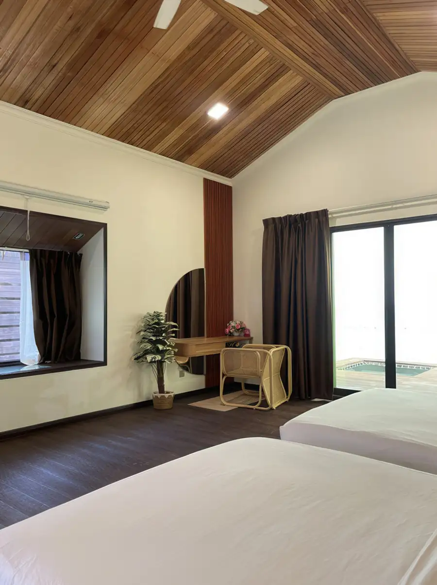 Modern white room with two beds and direct sea view at Dayang Resort Semporna, featuring clean lines, AC and large windows.