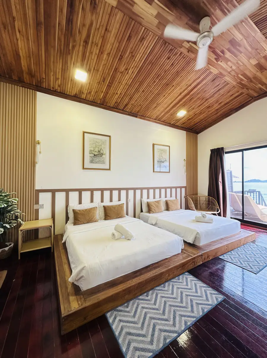 Premium twin villa interior at Dayang Resort Semporna with two beds and crisp white walls.