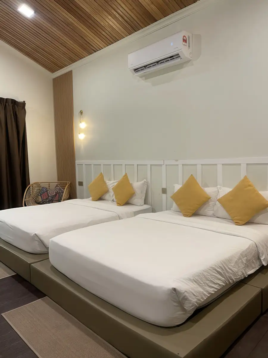 Spacious twin room interior at Dayang Resort Semporna with two large beds and clean modern styling.